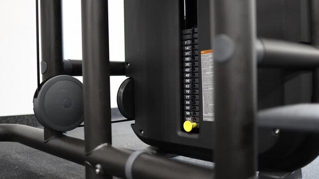Close up of gym weight stack set to maximum resistance on cable machine highlighting strength training intensity heavy workload and fitness progression