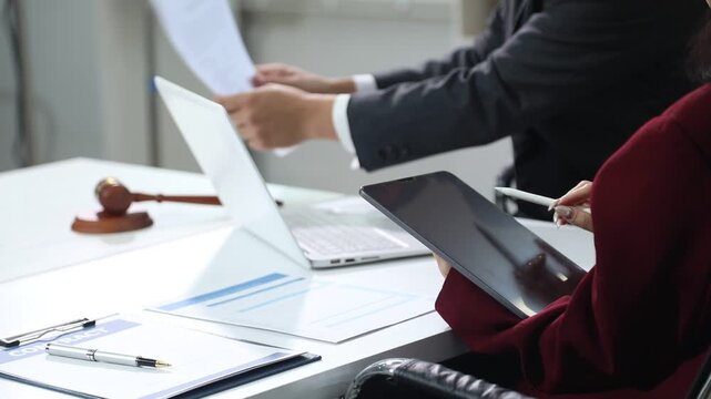 Close up of businessmen or lawyers discussing contract or business agreement at law firm office, Business people making deal document legal, justice advice service concept.