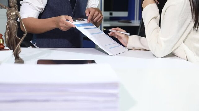 Close up of businessmen or lawyers discussing contract or business agreement at law firm office, Business people making deal document legal, justice advice service concept.