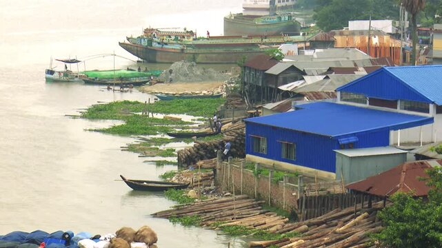Riverside Buildings and Moored Boats Along the Shitalakshya River in Bangladesh