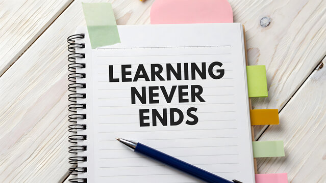 A spiral notebook with the inspirational quote learning never ends