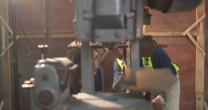Engineer Demonstrates Product Testing Machine to Startup Entrepreneur in Small Lab Workshop