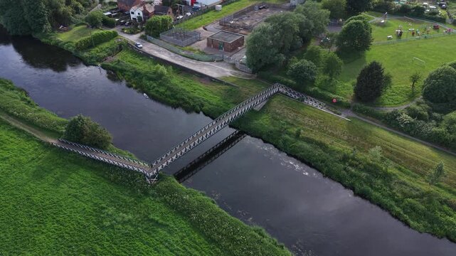 Aerial drone 4K scene showing residential streets bordered by natural greenery under soft daylight Burton on Trent