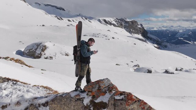  4K 59.94fps Cinematic drone orbit around a ski mountaineer on a rocky summit in Flims Laax, Swiss Alps, surrounded by rugged alpine terrain and snow-covered peaks.