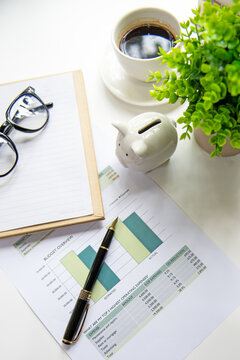 Piggy bank invest planning for retirement planning with saving and financial graph document. calculate and notebook for future financial security.  Financial Wellness for retirement Concept