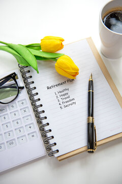 Retirement planning with saving, calculate notebook and tulip flower for future financial security.  Financial Wellness for retirement Concept