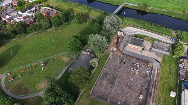 Aerial drone 4K footage showing the town edge bordered by meadow vegetation under soft daylight Burton on Trent
