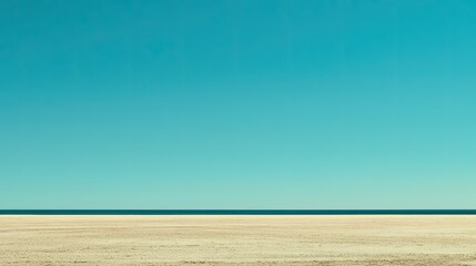 Obraz premium Vast, empty beach meets endless, serene blue sky and horizon