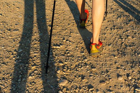 Hiker walking on trail with trekking poles