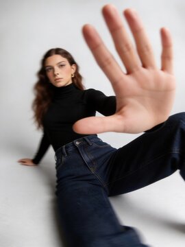 Female influencer in modern attire emphasizes motion with confident stance and soft lighting