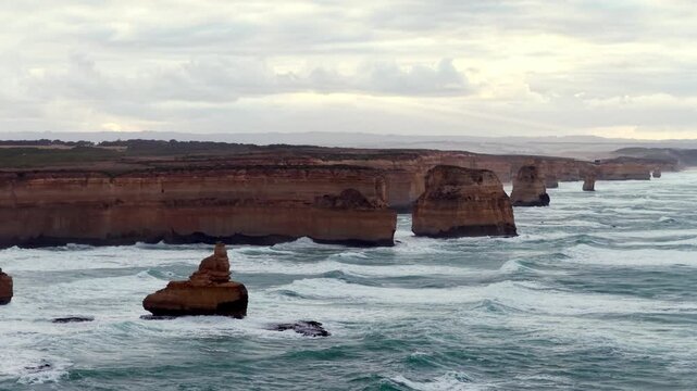 Seaside view of Twelve apostles rock formation eroded off Australian limestone coast.