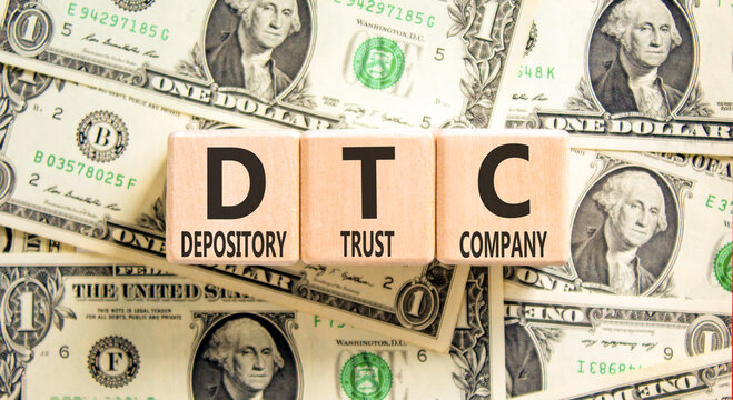 DTC depository trust company symbol. Concept words DTC depository trust company on beautiful wooden blocks. Beautiful dollar bills background. Business DTC depository trust company concept. Copy space