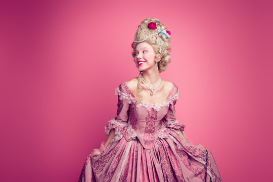 Photo of lovely pretty lady in 18th century outfit touch dress look empty space isolated pink color background