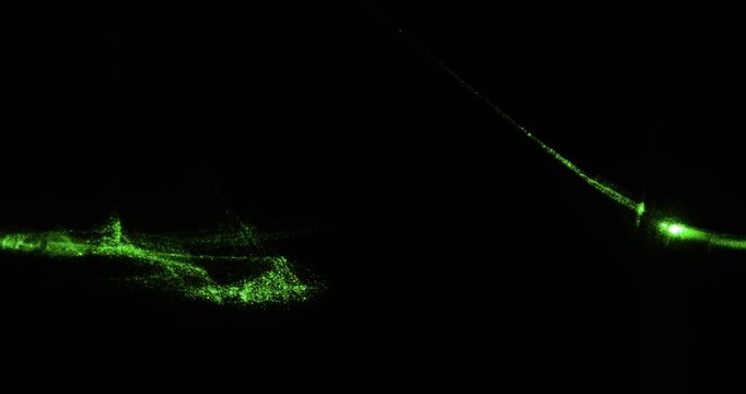 Glowing laser beam refraction and light patterns in macro view