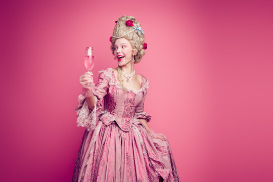 Photo of gorgeous pretty lady dressed pompous rococo costume enjoying champane empty space isolated pink color background