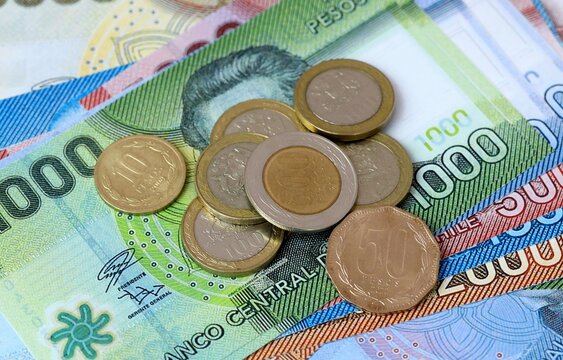 Chilean peso money bills and coins on table. Chile cash of CLP currency close up