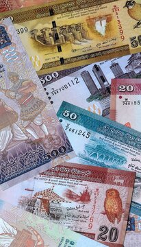 Sri Lankan rupee money banknotes bunch on table. Sri Lanka bills of LKR currency close up