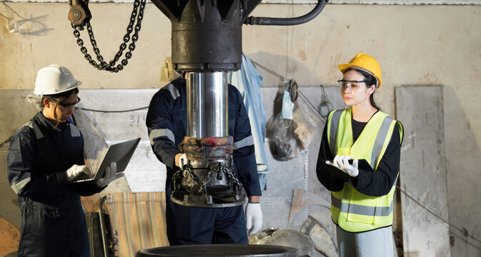 Job training, factory worker, engineer at work. Industrial engineer at work, discussion and working with factory machinery