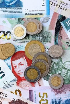 Mexican peso money banknotes and coins on table. Mexico cash bills of MXN currency