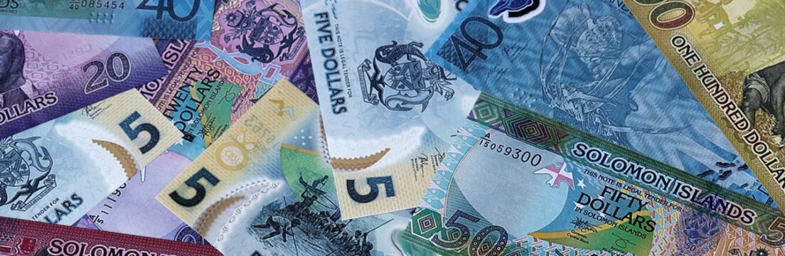 Solomon Islands dollar money bills in pile. Big amount of Solomon Islands SBD currency cash close up