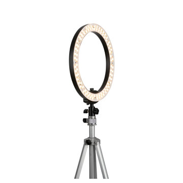 A circular ring light mounted on a silver tripod on transparent background