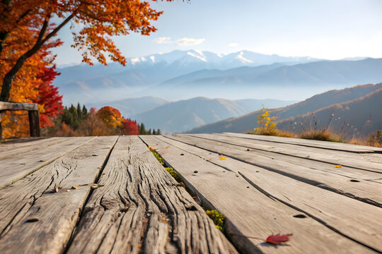 Old wooden bridge platform with autumn mountain landscape view under clear blue sky morning.