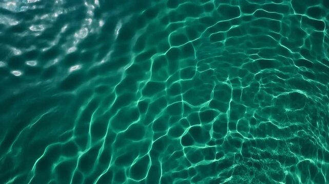 エメラルドグリーンと鮮やかなシアンの光の波紋が揺らめくコースティクスエフェクト