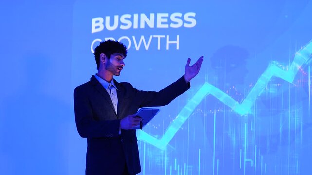 A male investment analyst presents the company's growth plan, including stock charts and computer-generated analysis of management systems, business intelligence, data statistics 