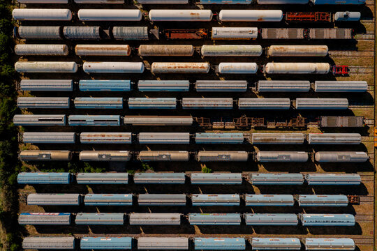Aerial view of numerous freight train cars parked in parallel rows at a rail yard in Saint-Denis-de-l'Hotel, Centre-Val de Loire, France.