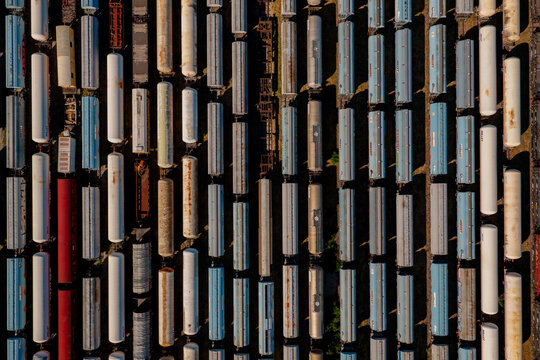 Aerial view of numerous freight train cars parked in parallel tracks at a rail yard in Saint-Denis-de-l'Hotel, Centre-Val de Loire, France.