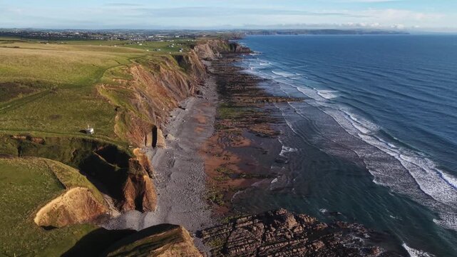 Late summers evening drone view at high tide on Cornish coast