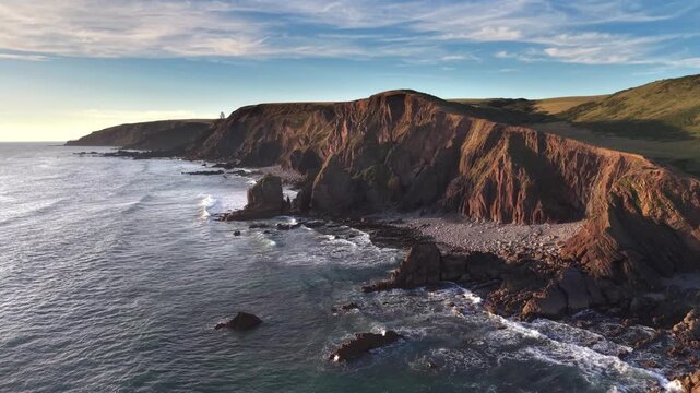 Dramatic aerial drone view of the Cornish coastline from Sandymouth Bay looking towards Eliza beach and Duckpool evening time