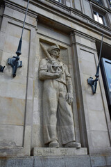 Fototapeta premium Social Realist Worker Sculpture on Historic Building Facade at Plac Konstytucji in Warsaw Poland