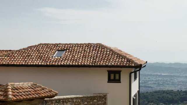 Mediterranean terracotta roof house with skylight scenic european architecture detail.