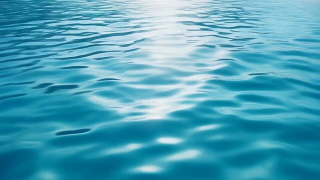 Tranquil blue water surface with gentle ripples reflecting bright sunlight for a peaceful background texture