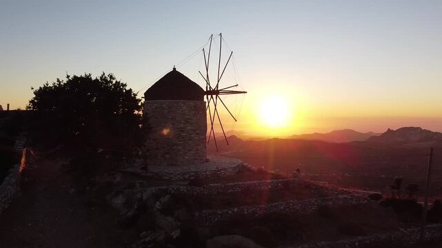 Sunset Unveiling Shot on a Windmill viewpoint in Naxos Greece