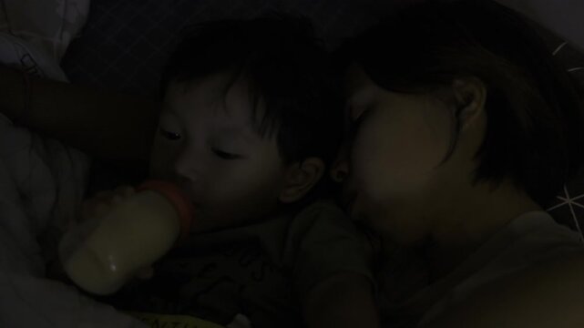 Mom Sleeping While Baby Drinks From Bottle