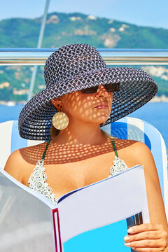 Cruise on a sailing yacht. Beautiful girl sunbathe in the sun and drink cocktails in the jacuzzi. Yachting. Sailing. Travel	