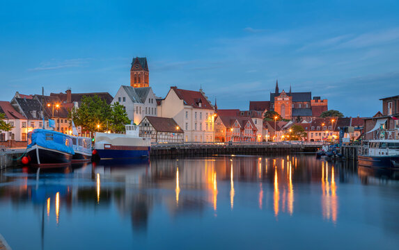 Wismar, Germany - panoramic view of city skyline from Old Port (Alter Hafen) at dusk