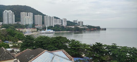 Scenic view of coastal high-rise buildings and sandy beach in Batu Ferringhi, Penang, Malaysia © sahrul
