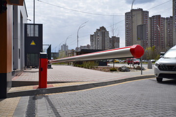 Automatic red boom barrier at residential parking entrance © Sergey