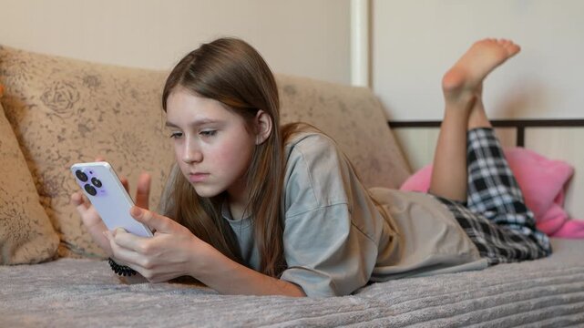 Smiling woman holding mobile phone in bed shopping girl smartphone morning bedroom Caucasian female teen relaxing comfort weekend home scrolling cellphone online social media