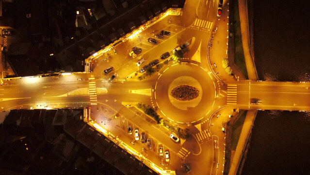 Aerial view of a roundabout illuminated by streetlights at night in Pontoise, Ile-de-France, France.