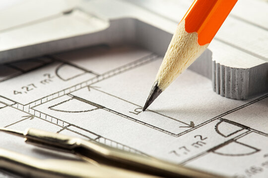pencil makes marks on blueprints. Concept of industrial and real estate construction.