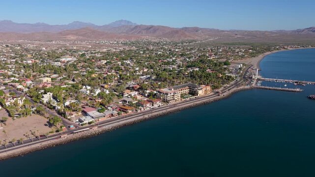 Witness the sunrise light up the historic waterfront and malecon in Loreto, Baja California Sur, Mexico with stunning aerial views.