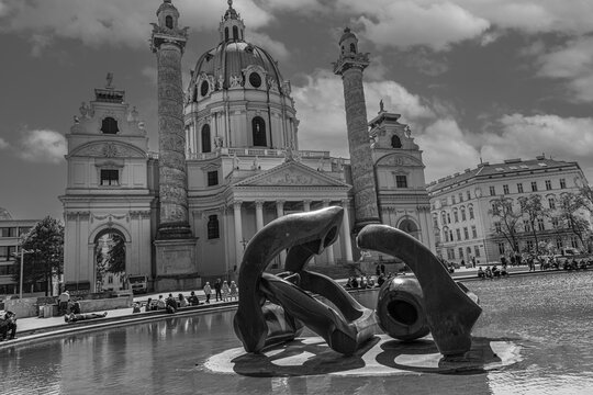 Bronze sculptures in the pond in front of the baroque Karlskirche, black and white photo, Karlsplatz, Vienna, Austria