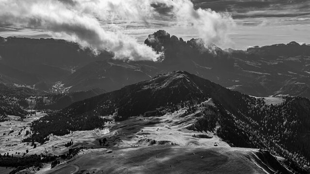 The Picberg, in the background the peaks of the Sassolungo group, shrouded in fog, drone shot, black and white, Val Gardena, Dolomites, Autonomous Province of Bolzano, South Tyrol, Italy
