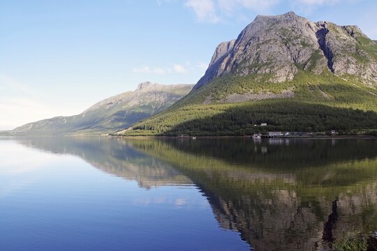 Steep mountains reflected in the sea, fjord, shore, Jektvik, Kystriksveien, FV 17, Helgeland, Nordland, Norway