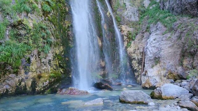 Albania Theth showcases its natural beauty with majestic waterfalls cascading into crystal-clear pools.