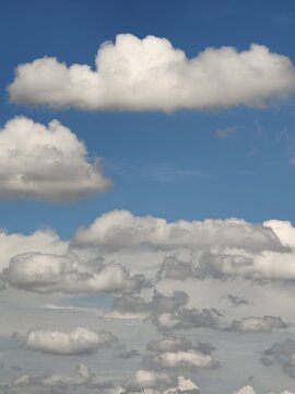Scattered Cumulus Clouds Floating in Clear Blue Sky
